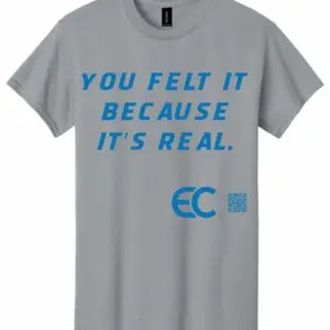 Gray t-shirt with blue text saying "You felt it because it's real."